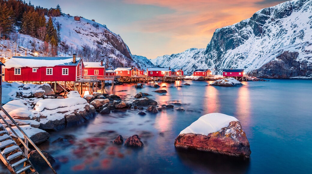 Fantastic evening cityscape of Nusfjord town, Norway, Europe. Great sunset on Lofoten Island archipelago. Fabulous winter seascape of Norwegian sea. Life over polar circle.