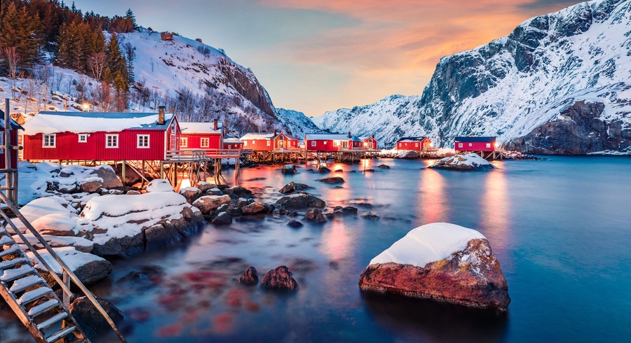 Fantastic evening cityscape of Nusfjord town, Norway, Europe. Great sunset on Lofoten Island archipelago. Fabulous winter seascape of Norwegian sea. Life over polar circle.