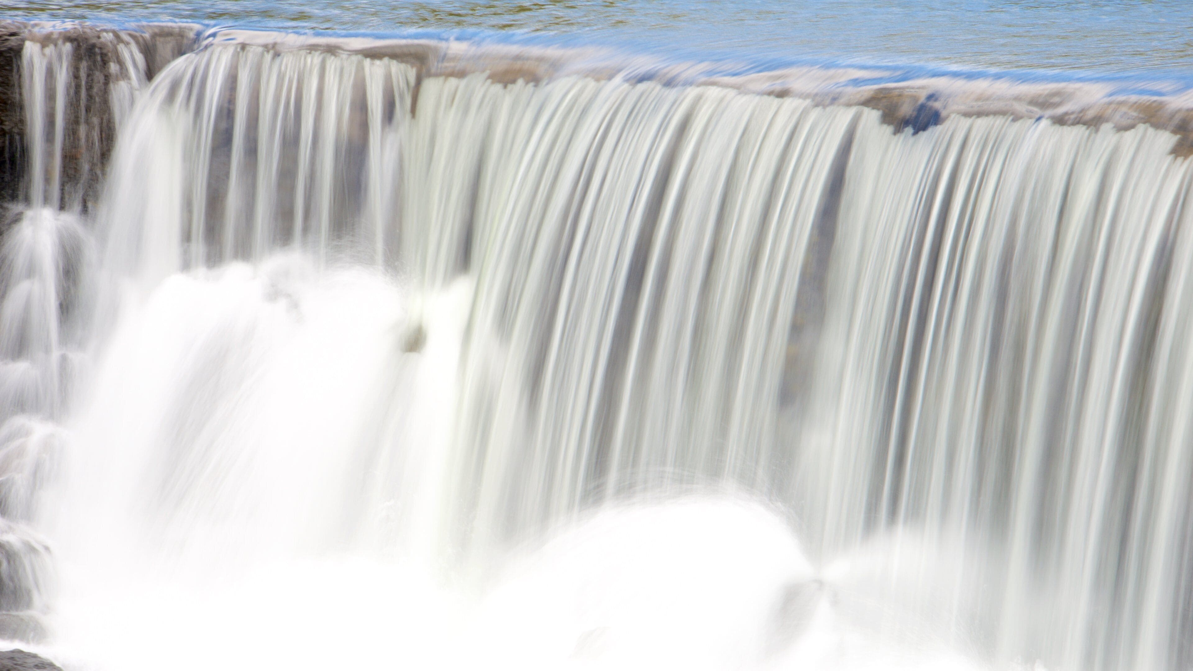 Chute de la Madeleine Lookout which includes a waterfall