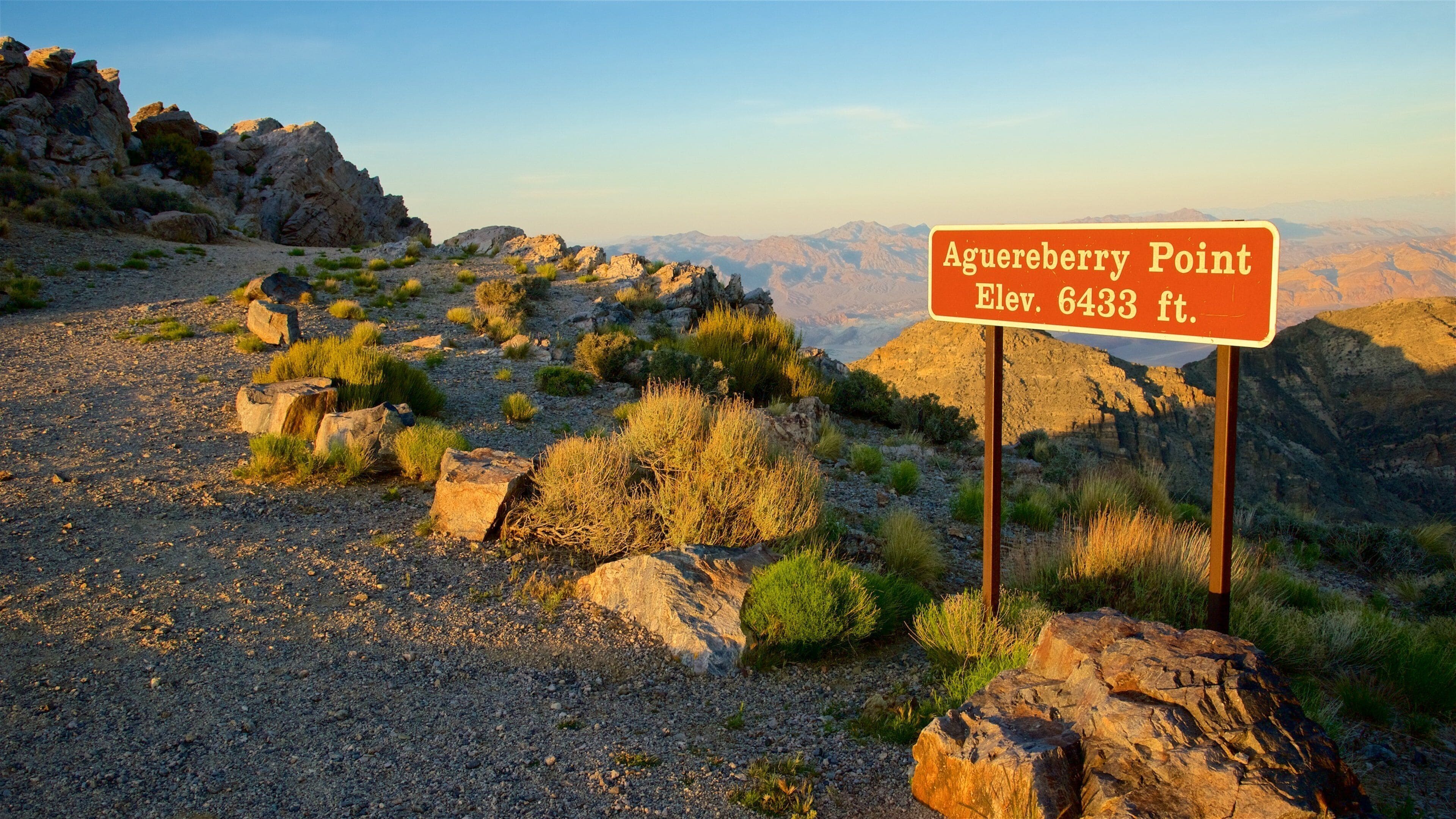 A rocky terrain with a sign indicating Aguereberry Point at an elevation of 6433 ft.