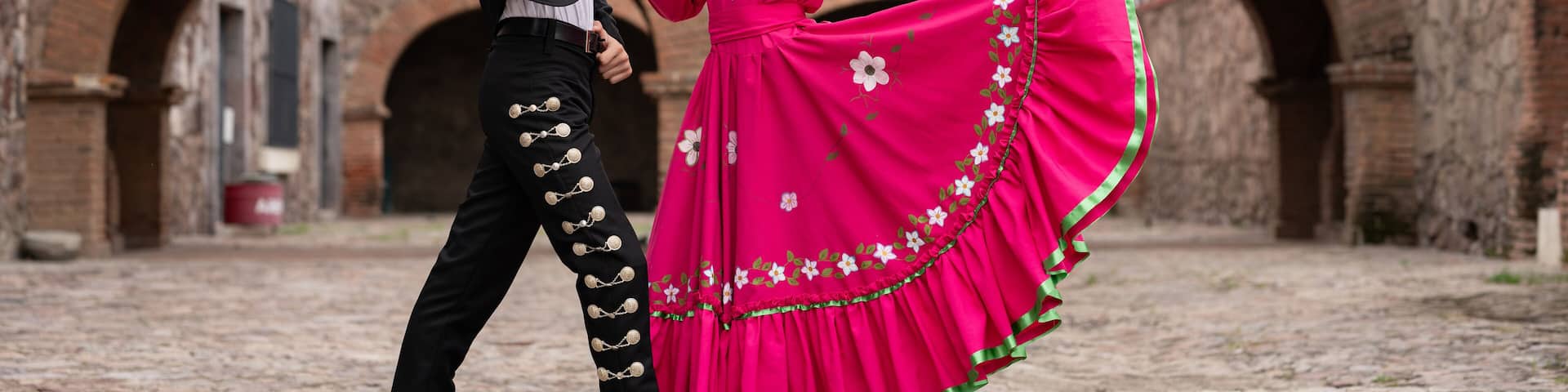 Latin couple of dancers wearing traditional Mexican dress from Guadalajara Jalisco Mexico Latin America, young hispanic woman and man in independence day or cinco de mayo parade or cultural Festival