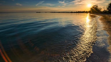 Scenery from the beautiful sandy setting of the Big Sandy Bay beach on Wolfe Island in Frontenac County near Kingston Ontario Canada. Windmills and beautiful water landscapes.