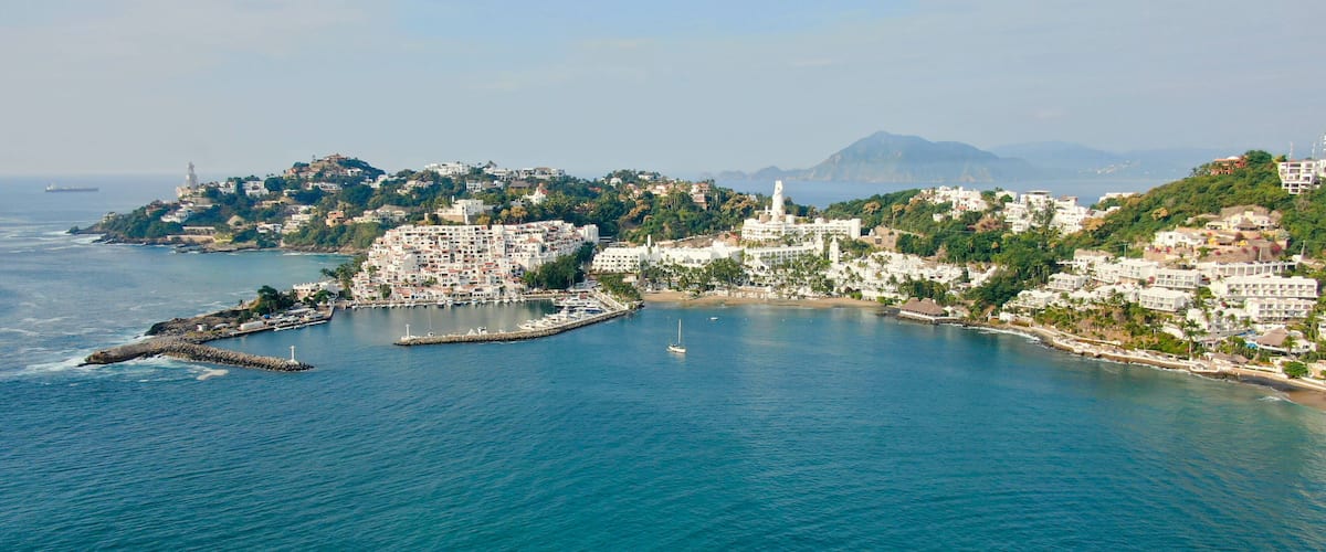 Aerial view of Peninsula de Santiago in city Manzanillo, Mexico. Beautiful bitch, luxury hotels and yachting bay.