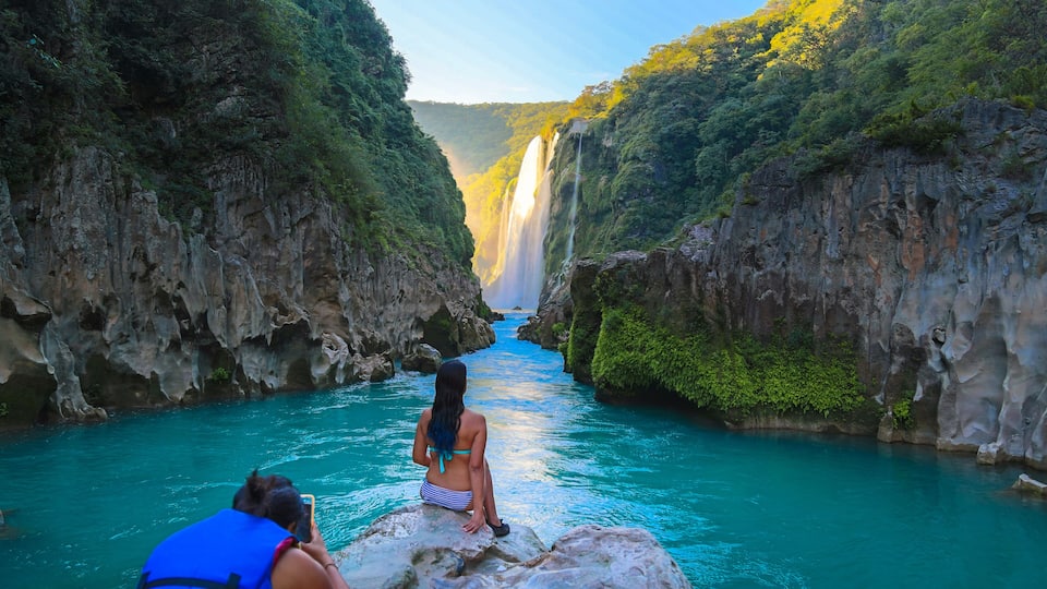 TAMUL, SAN LUIS POTOSI MEXICO - January 6, 2020:young women posing in River amazing crystalline blue water of Tamul waterfall