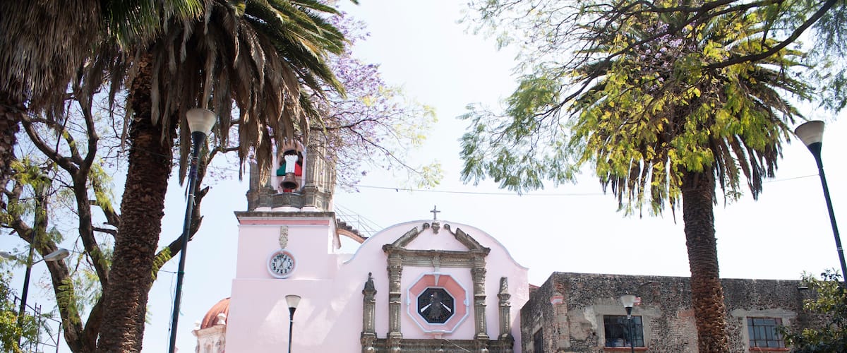 Stone church in Asunción neighborhood wrapped between cobbled streets and fruit and ornamental trees give life to the town