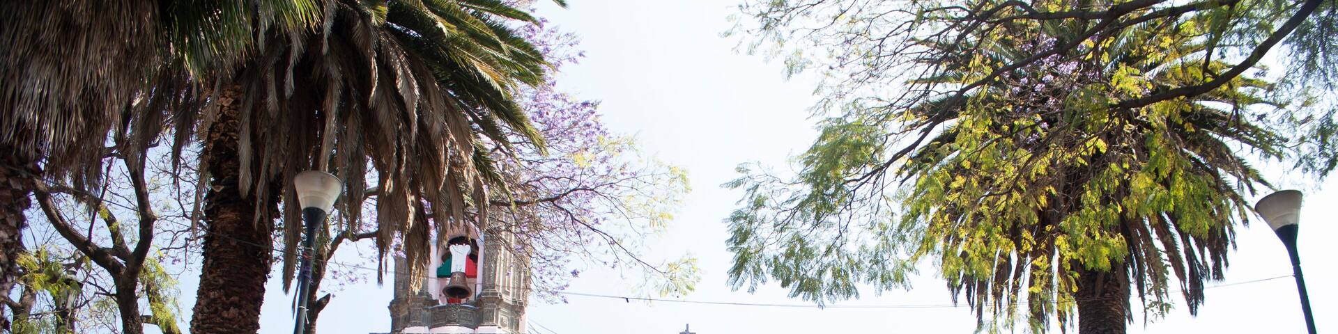 Stone church in Asunción neighborhood wrapped between cobbled streets and fruit and ornamental trees give life to the town