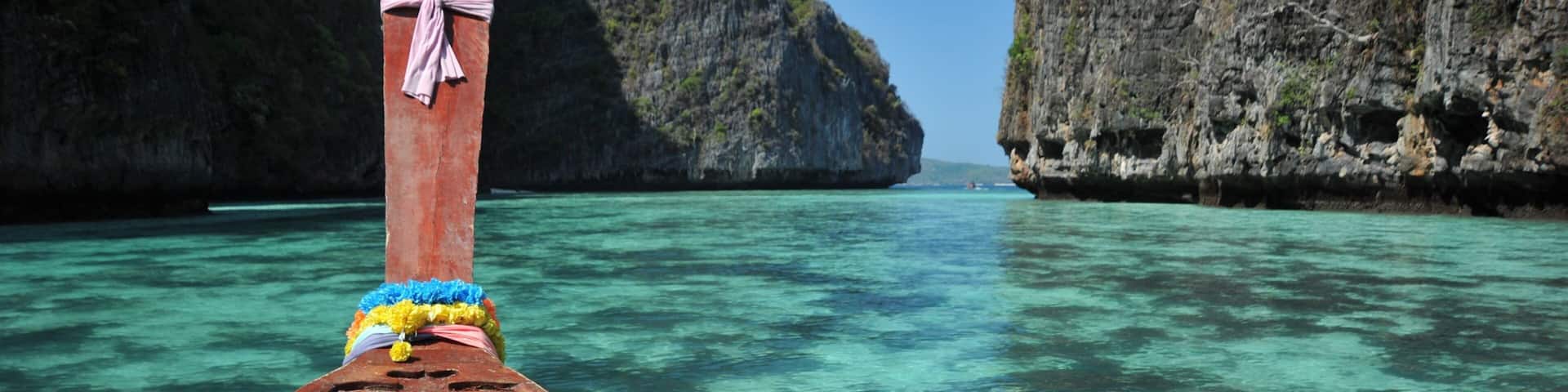 Phi Phi Islands featuring rugged coastline, boating and tropical scenes