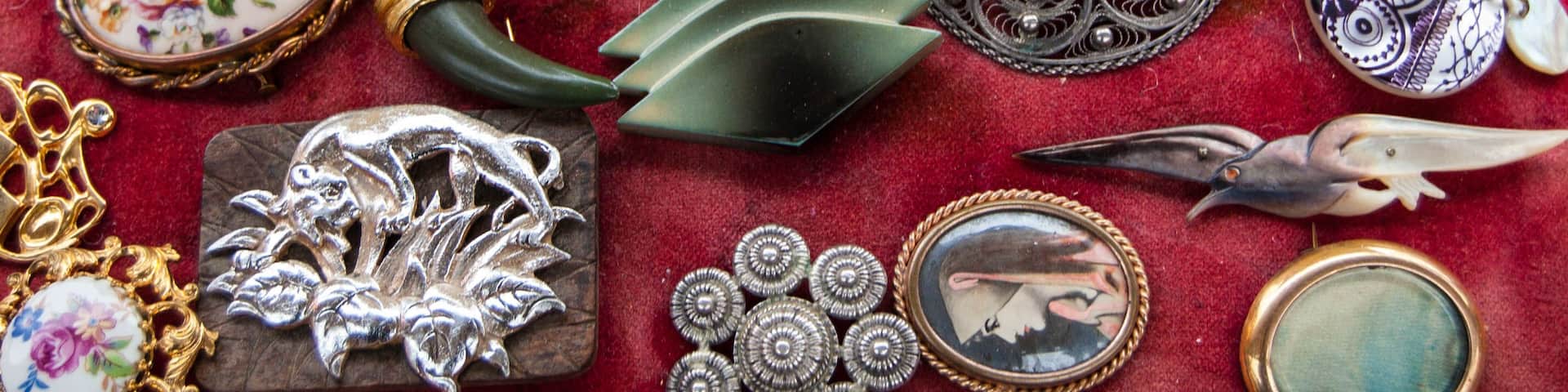Jewelry background. Vintage brooches at flea market in Paris (France).