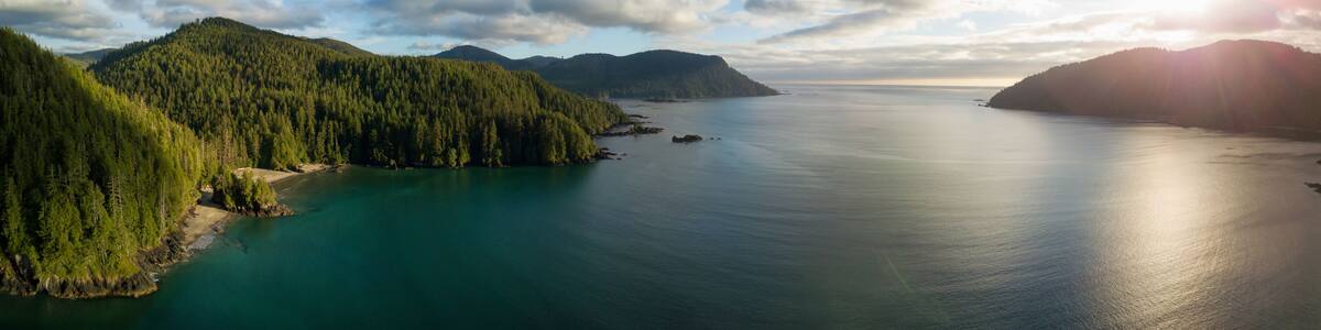 Striking aerial panoramic view of the Pacific Ocean Coast during a vibrant summer sunset. Taken in San Josef Bay, Cape Scott, Northern Vancouver Island, BC, Canada.
