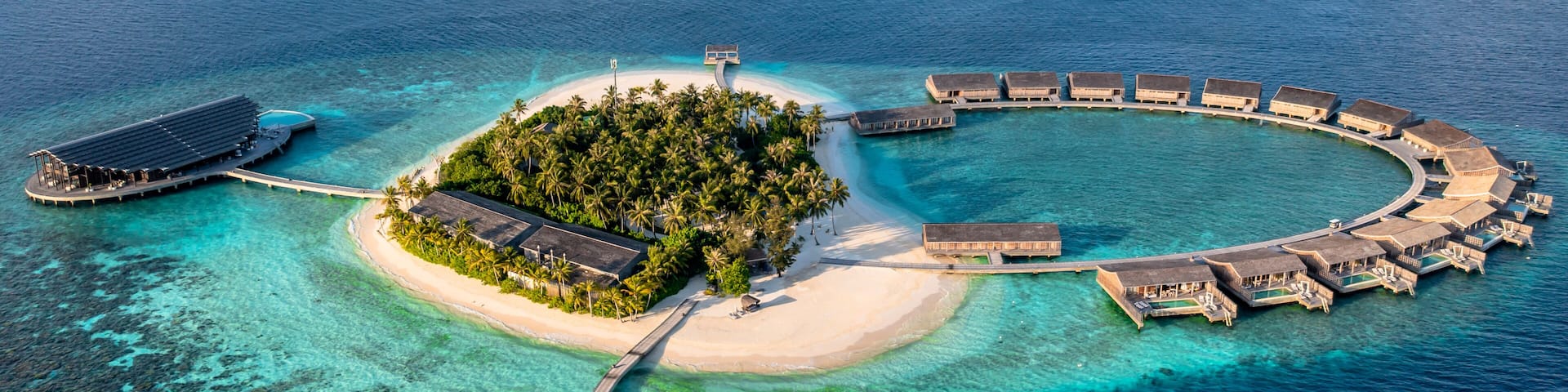Aerial view of bungalows surrounded by blue sea at Kudadoo island, Maldives