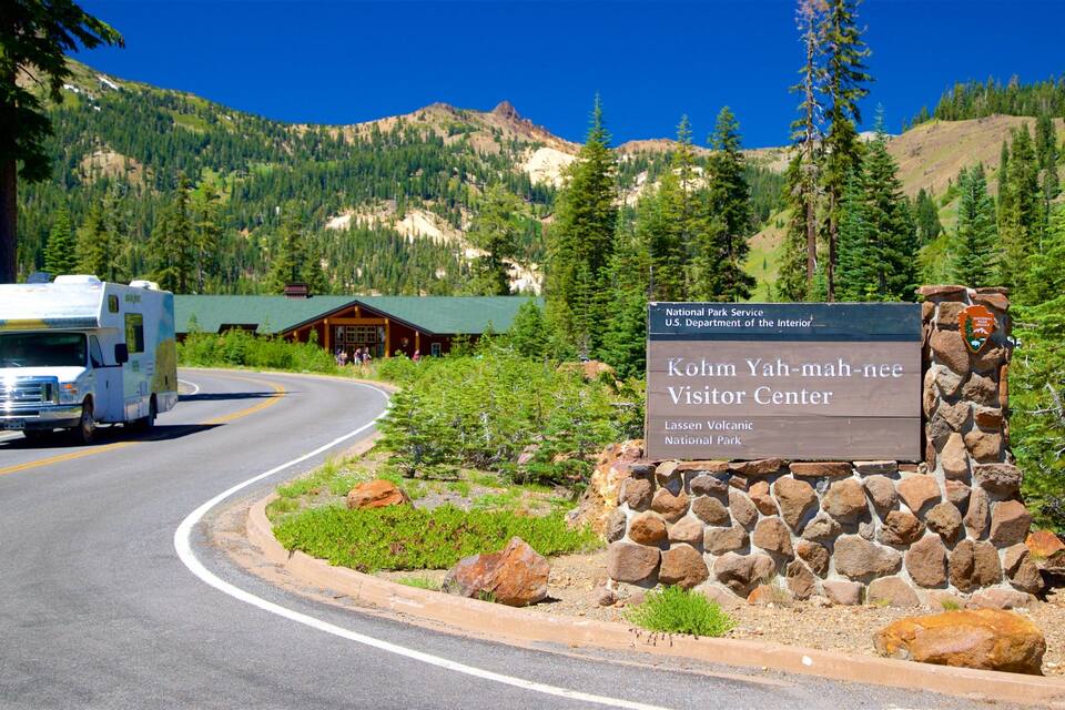 A road leading to the Kohm Yah-mah-nee Visitor Center with a camper parked nearby.