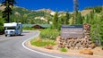 A road leading to the Kohm Yah-mah-nee Visitor Center with a camper parked nearby.