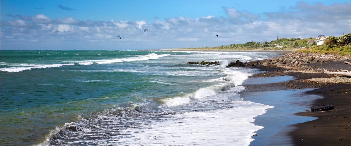 Taranaki featuring waves and rugged coastline