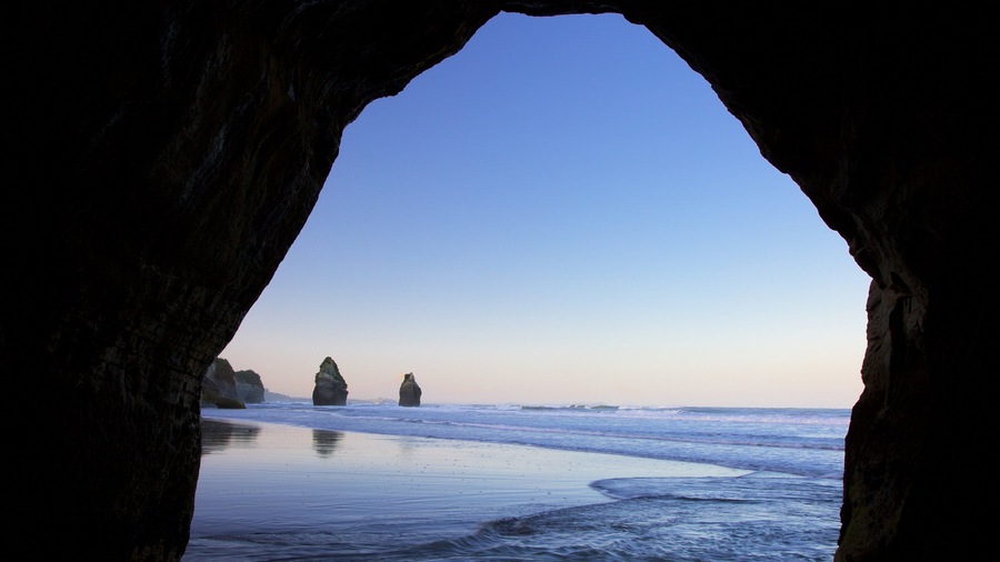 Tongaporutu showing a sandy beach, a bay or harbour and rugged coastline