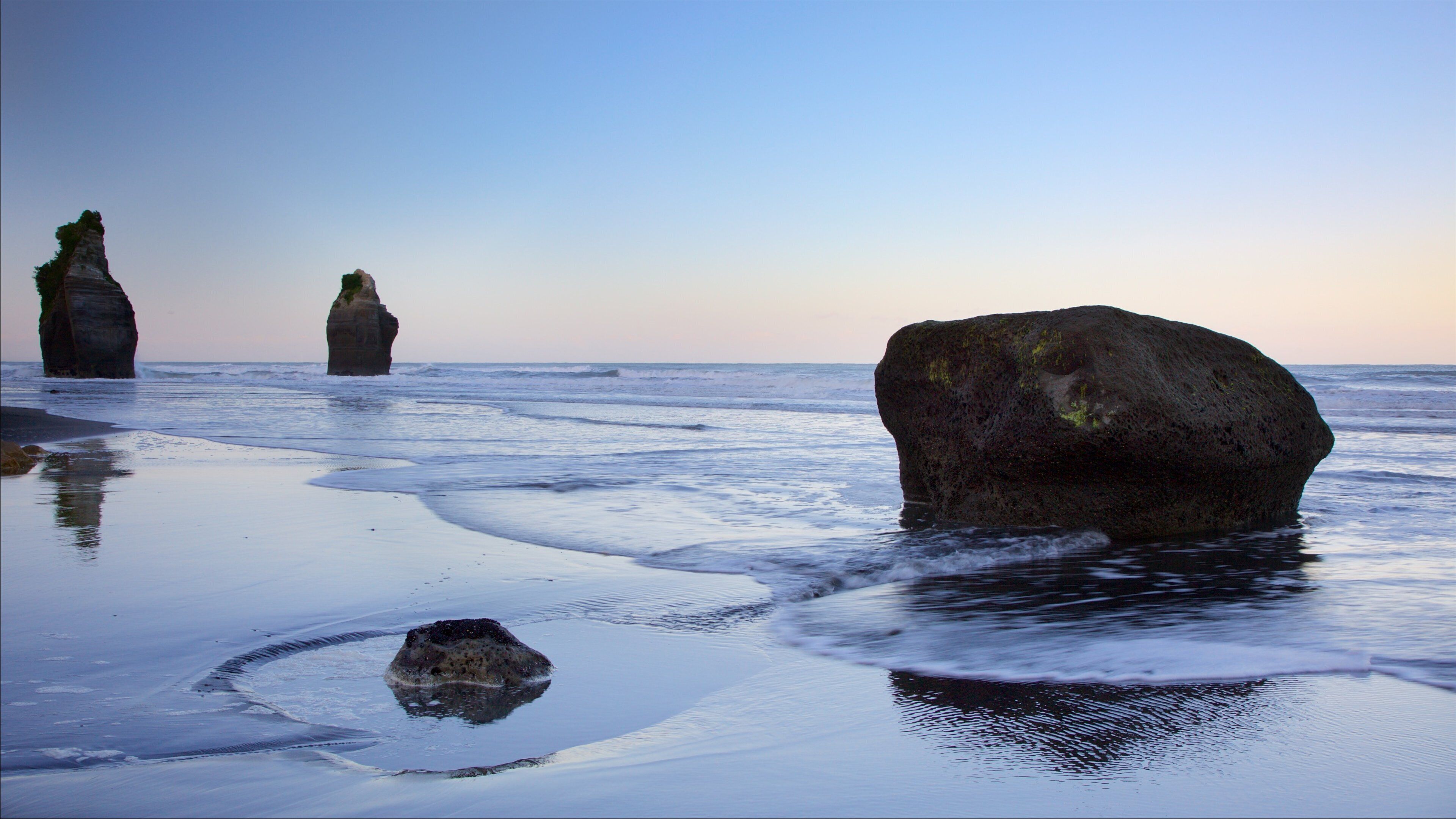 Taranaki featuring a bay or harbour, a sunset and rocky coastline