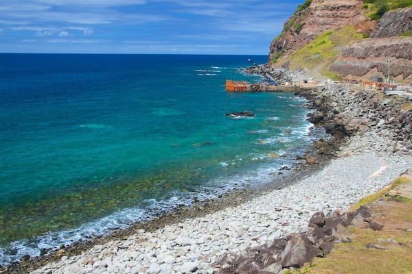 Norfolk Island which includes a pebble beach, rugged coastline and general coastal views