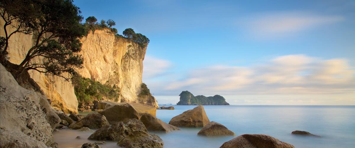 Stingray Bay showing rugged coastline, a sandy beach and a sunset