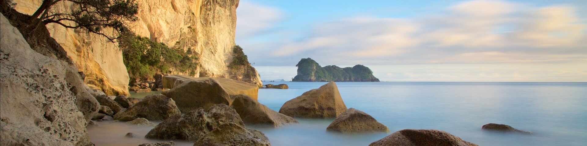 Stingray Bay showing rugged coastline, a sandy beach and a sunset