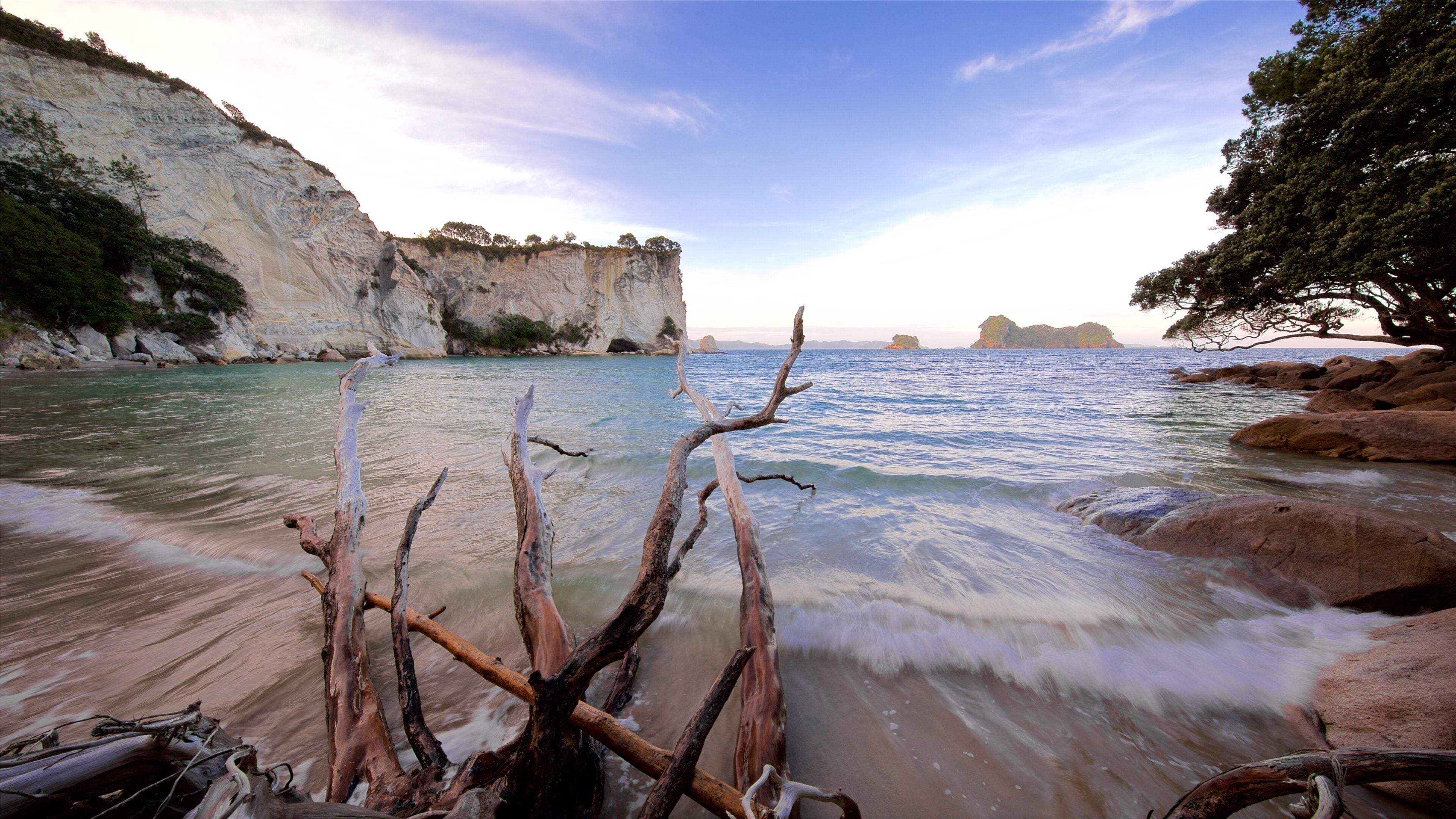 Stingray Bay showing a sunset, rocky coastline and a beach