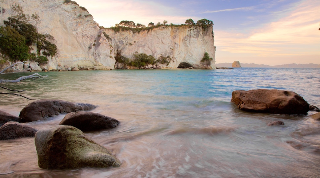 Whitianga which includes rocky coastline, a sunset and a bay or harbor