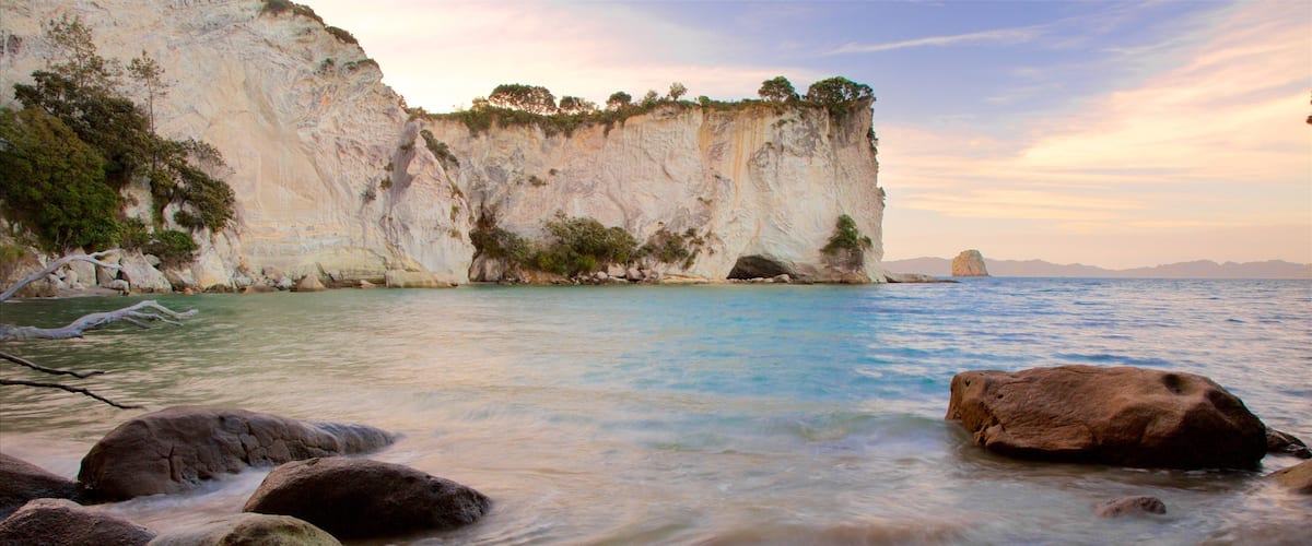 Whitianga showing a bay or harbor, a sunset and rocky coastline