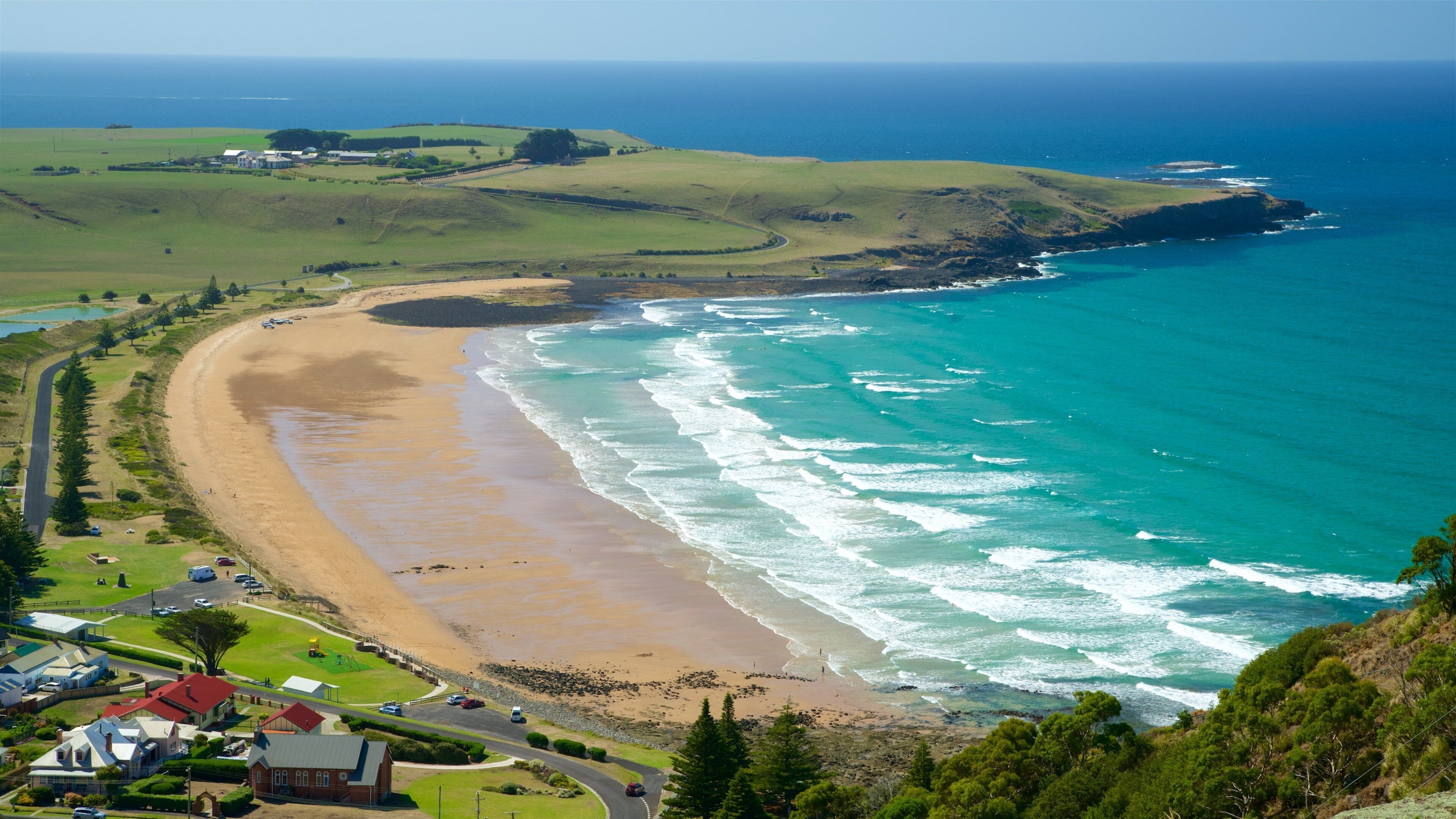 Perkins Bay featuring a beach, a coastal town and waves