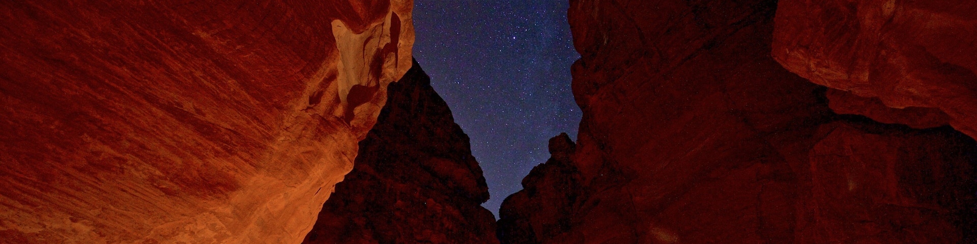 al-Siq showing a gorge or canyon and night scenes