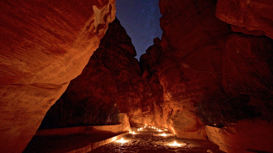 al-Siq showing a gorge or canyon and night scenes
