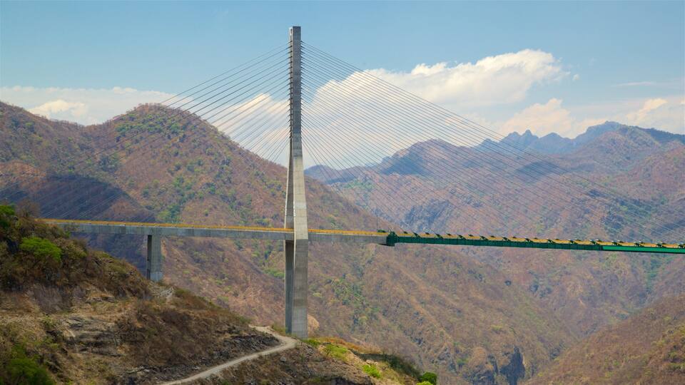 A cable-stayed bridge with a mountainous backdrop.