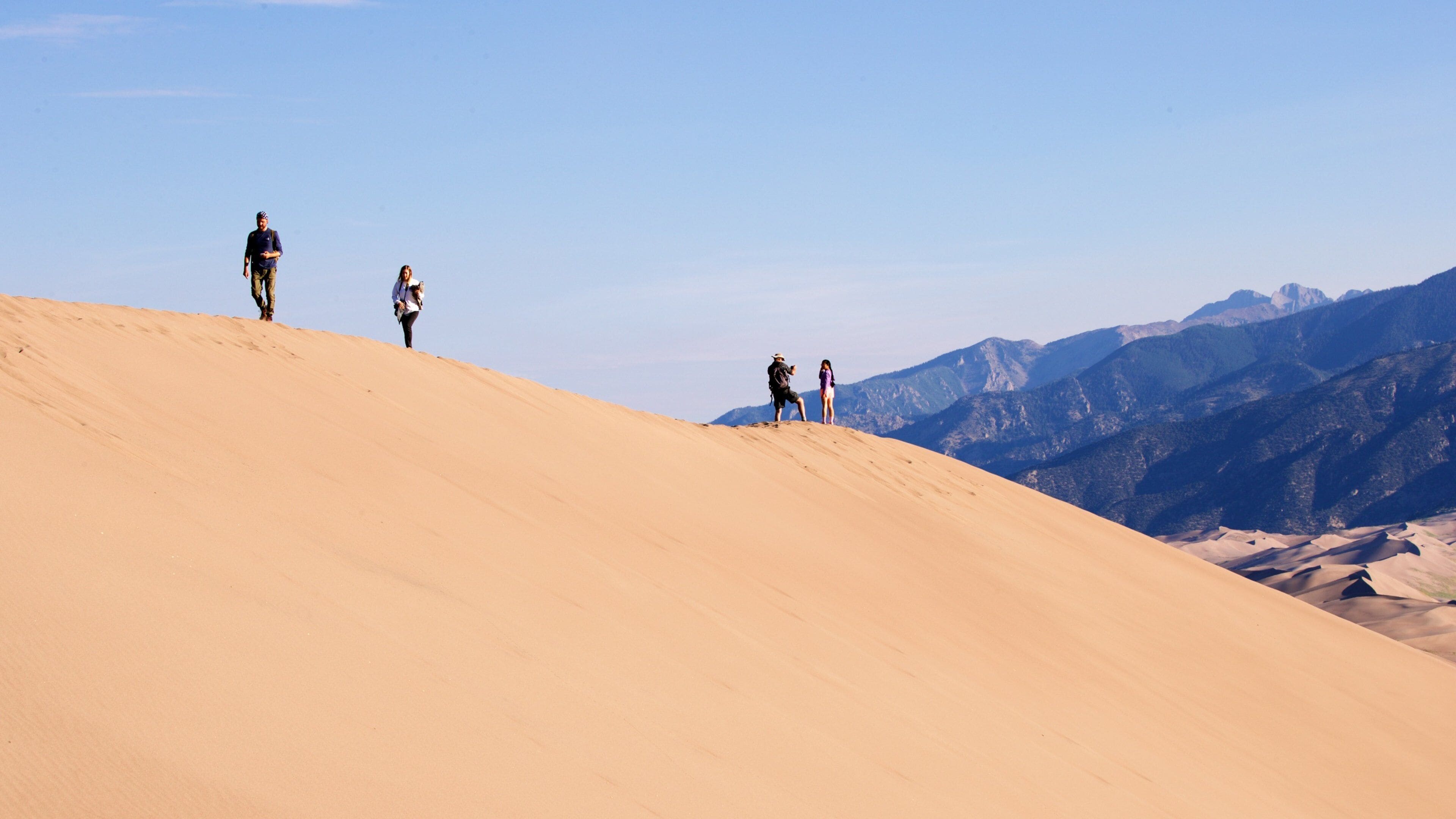 High Dune which includes landscape views and desert views as well as a small group of people
