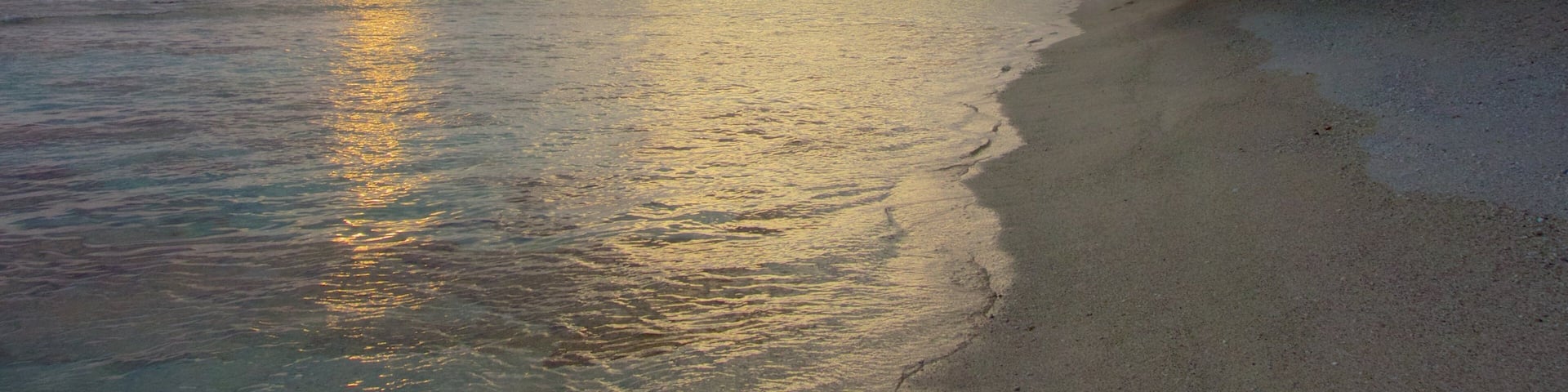 Atiu showing a sunset and rocky coastline