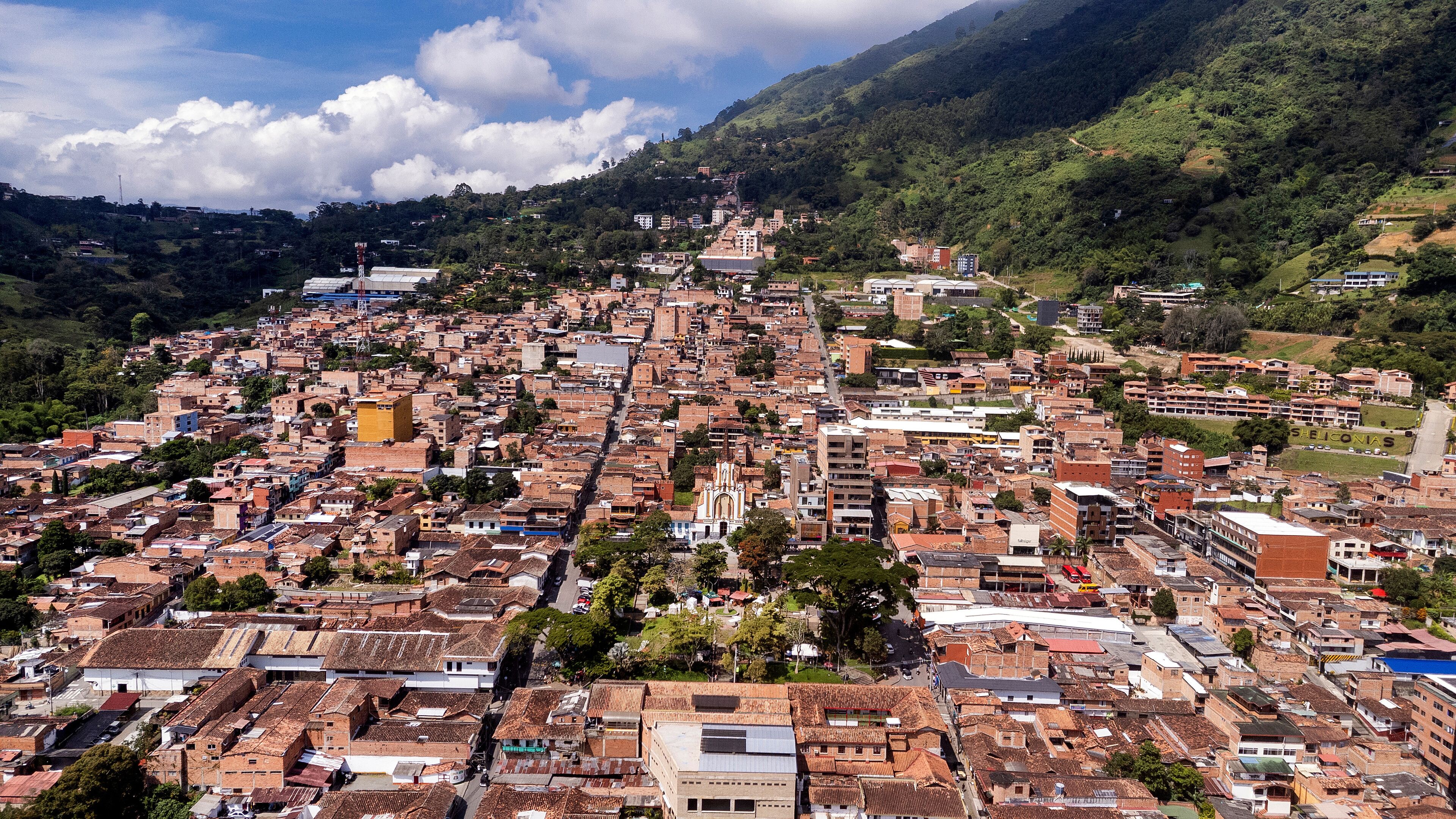 A densely packed urban area with a prominent church and surrounding greenery.