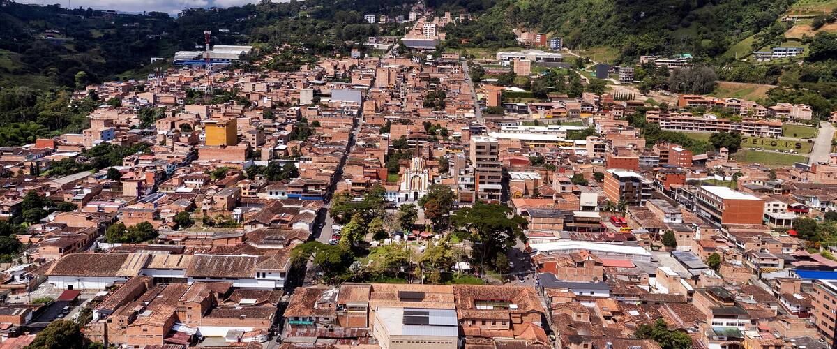 A densely packed urban area with a prominent church and surrounding greenery.