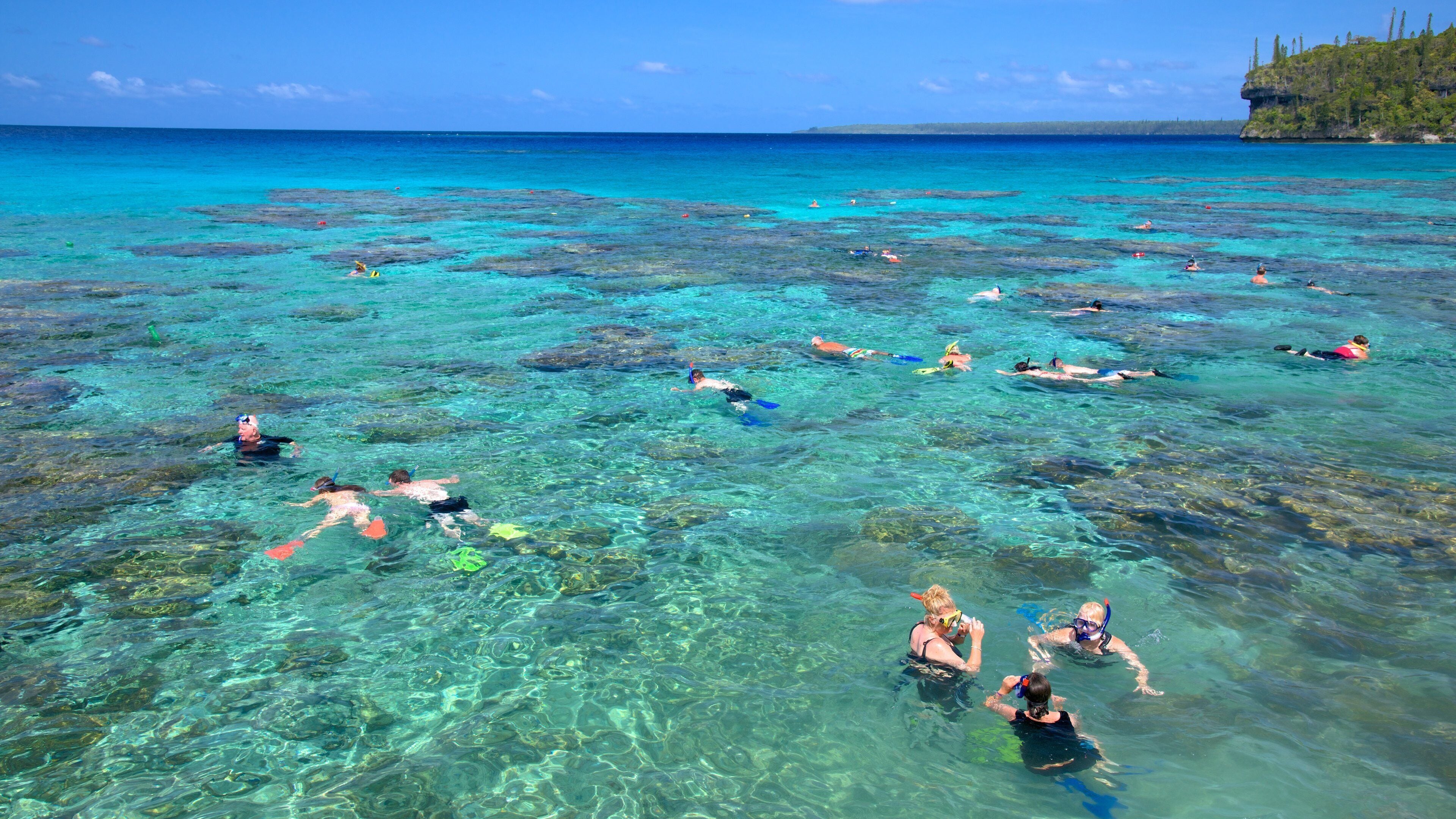 Lifou which includes colourful reefs and snorkelling as well as a large group of people