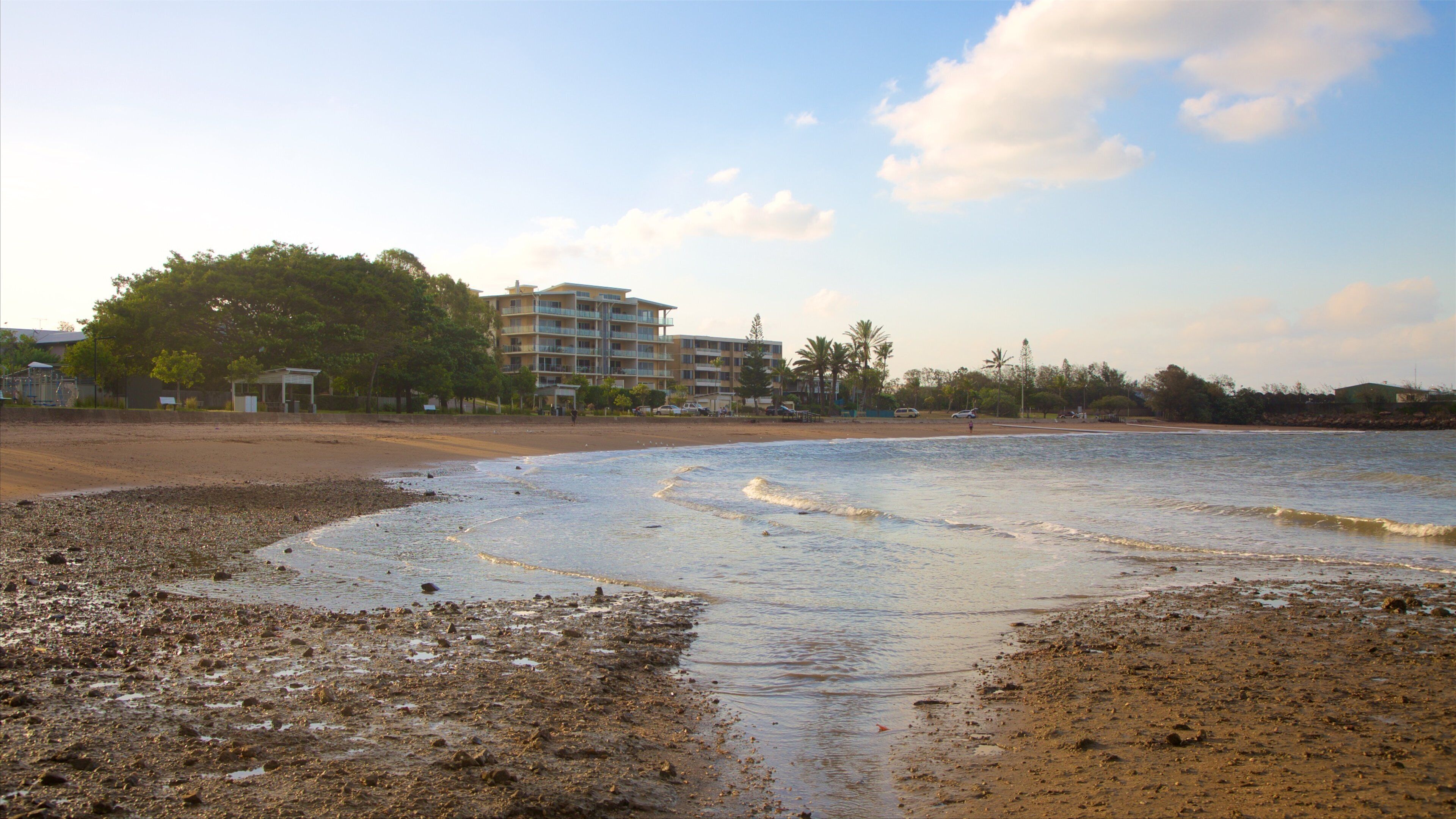 Barney Point Beach featuring a sandy beach, a coastal town and a sunset