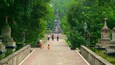 Mendut Buddhist Monastery which includes a park and heritage elements as well as a small group of people