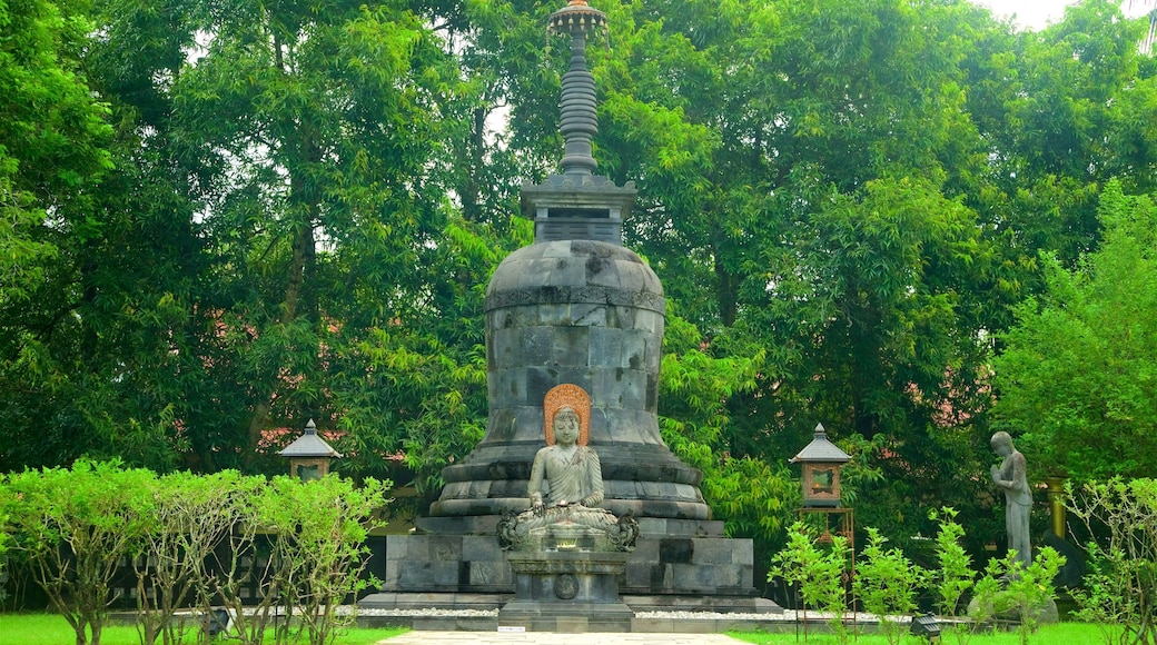 Mendut Buddhist Monastery featuring a fountain and a garden
