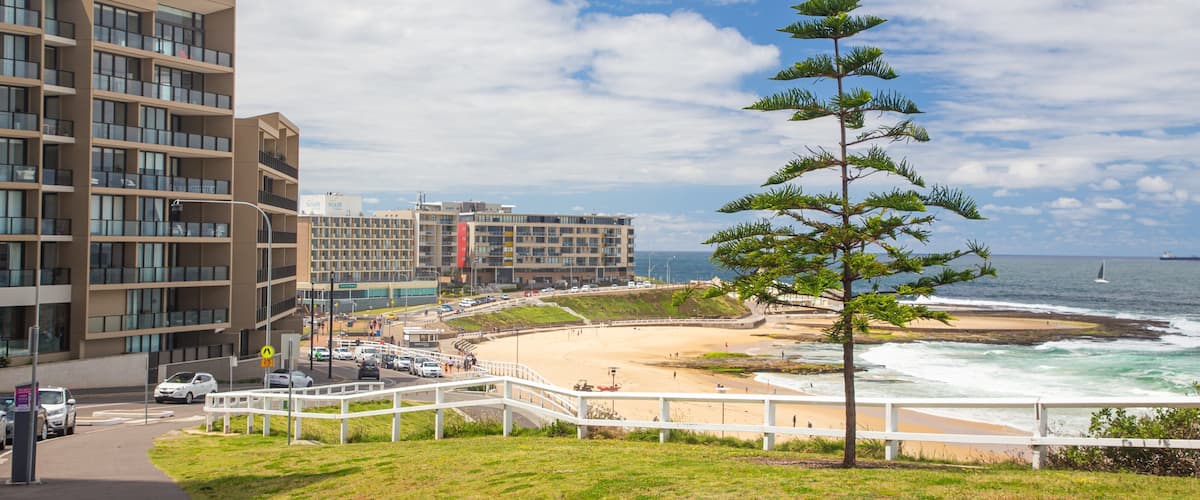 Newcastle Beach featuring a beach, a coastal town and general coastal views
