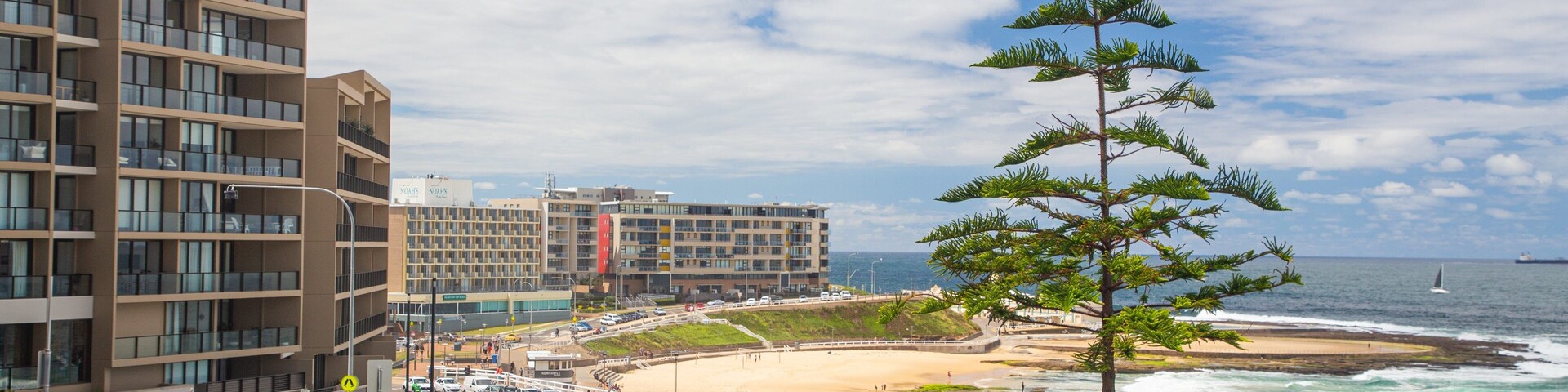 Newcastle Beach featuring a beach, a coastal town and general coastal views