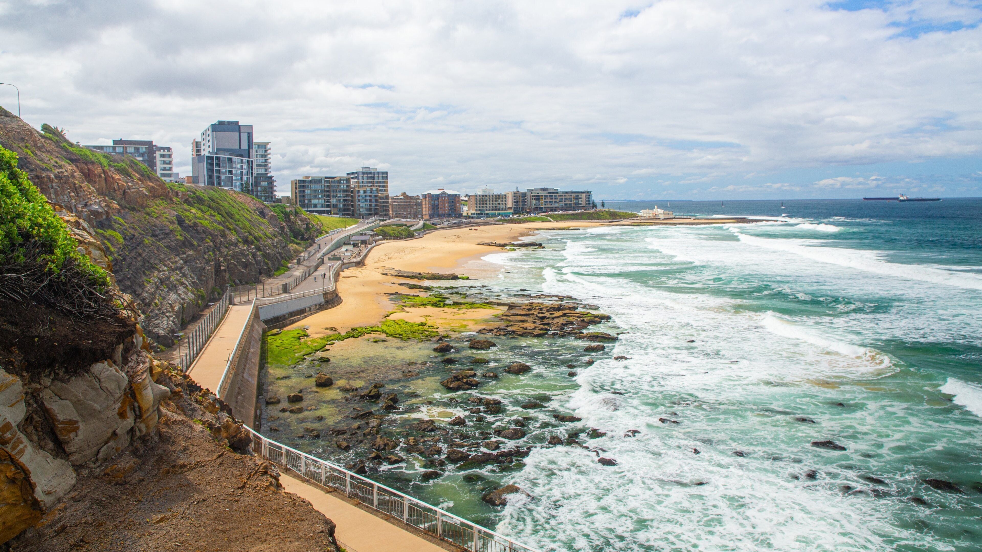 Newcastle Beach showing a beach, a coastal town and general coastal views