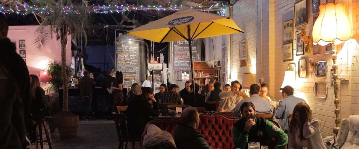 Moon Dog Craft Brewery showing a bar and night scenes as well as a small group of people