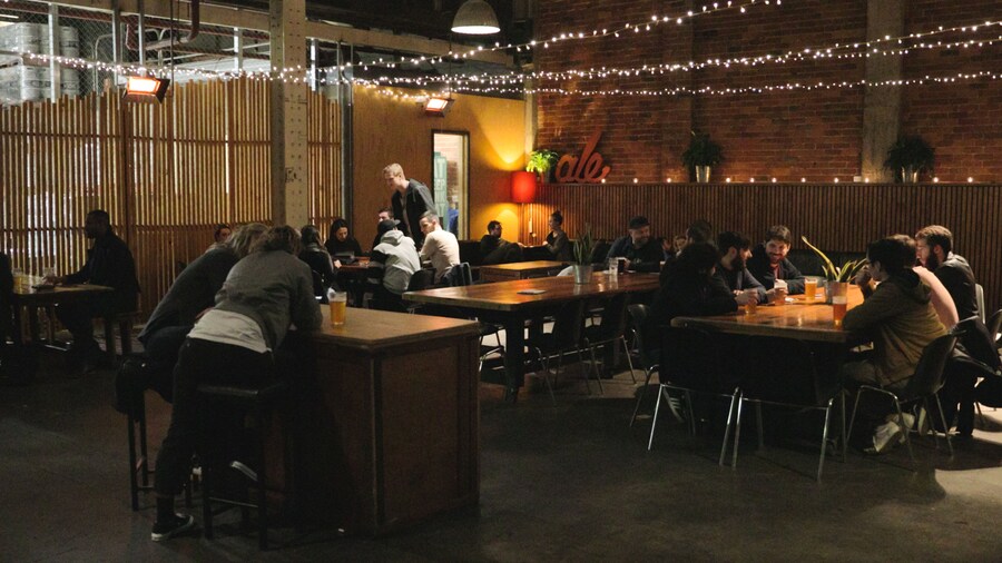 Mountain Goat Beer Brewery showing a bar and interior views as well as a small group of people