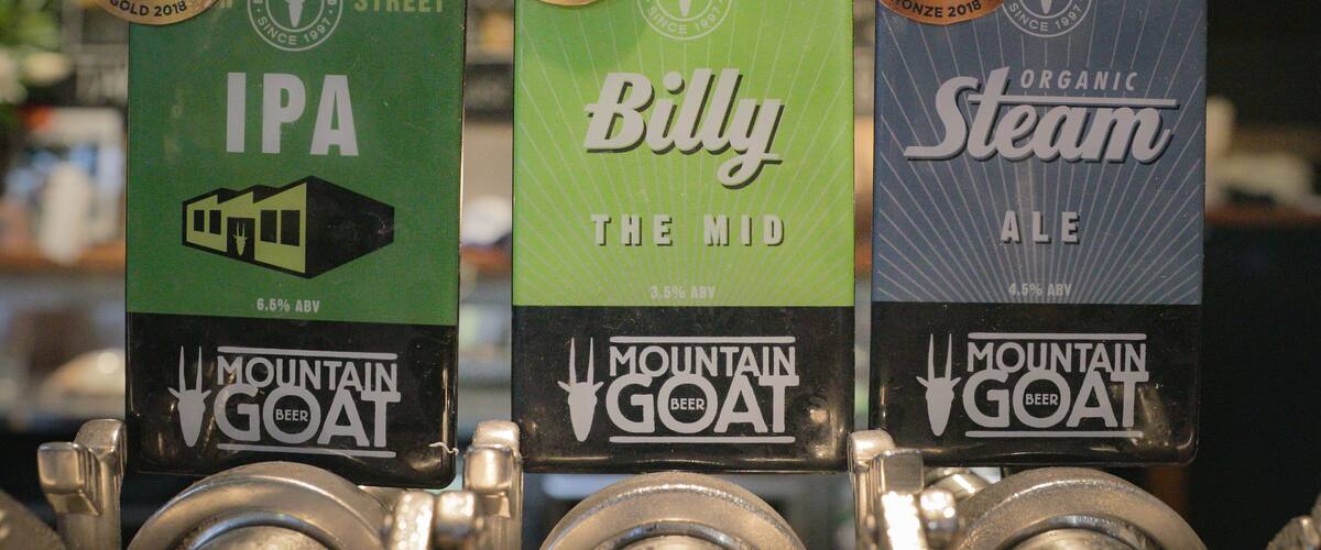 Mountain Goat Beer Brewery featuring signage and a bar