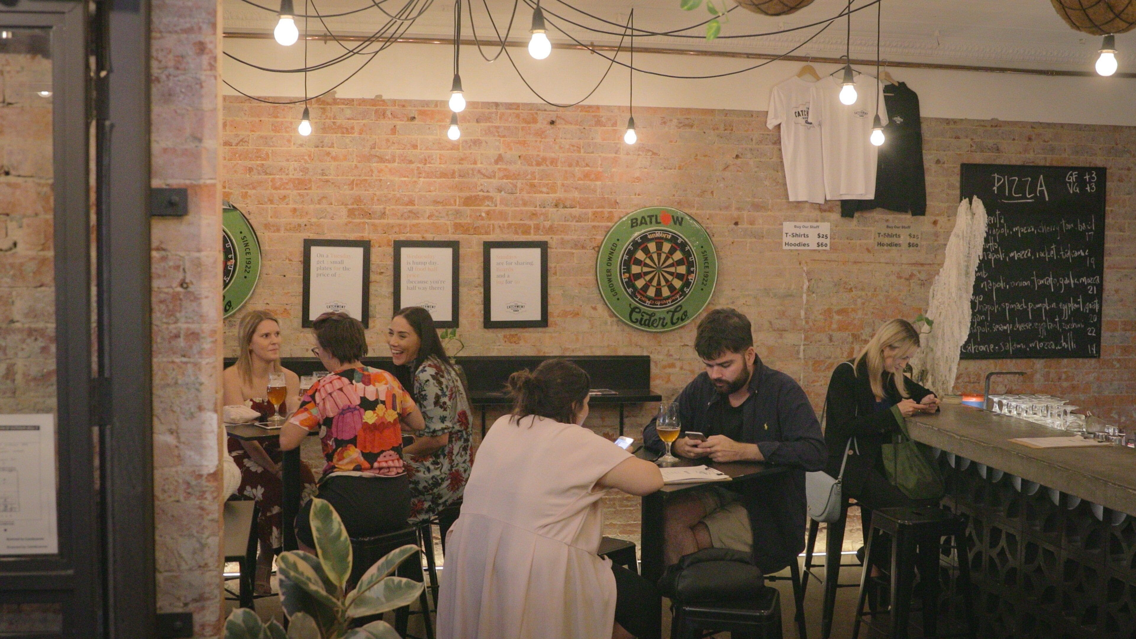 The Catchment Brewing Co. showing nightlife and a bar as well as a small group of people