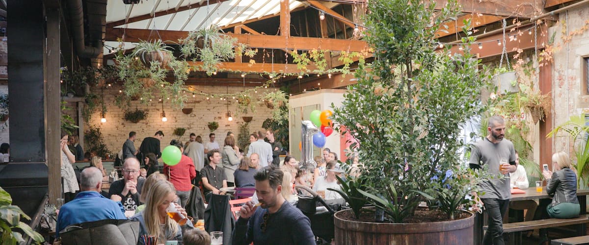 Stomping Ground Brewery showing interior views and cafe lifestyle as well as a small group of people