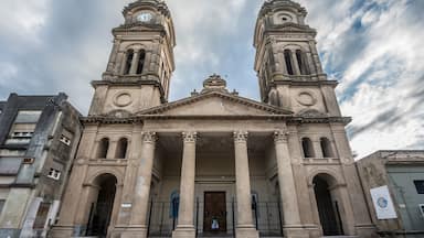 A historic building with two clock towers and a central entrance with columns.