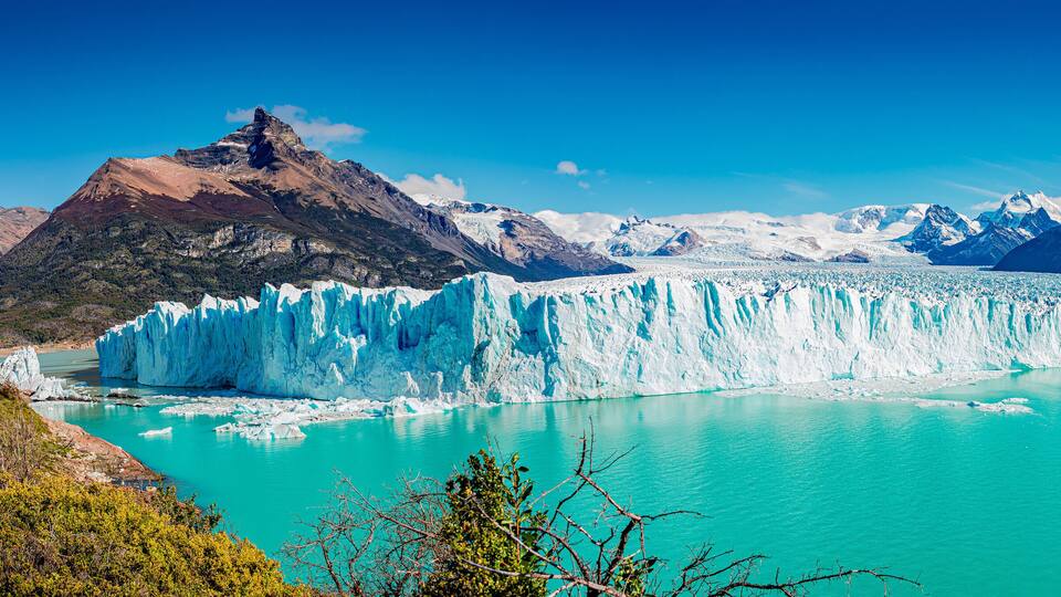 Panoramic view of the gigantic Perito Moreno glacier, its tongue and lagoon in Patagonia in golden Autumn, Argentina
