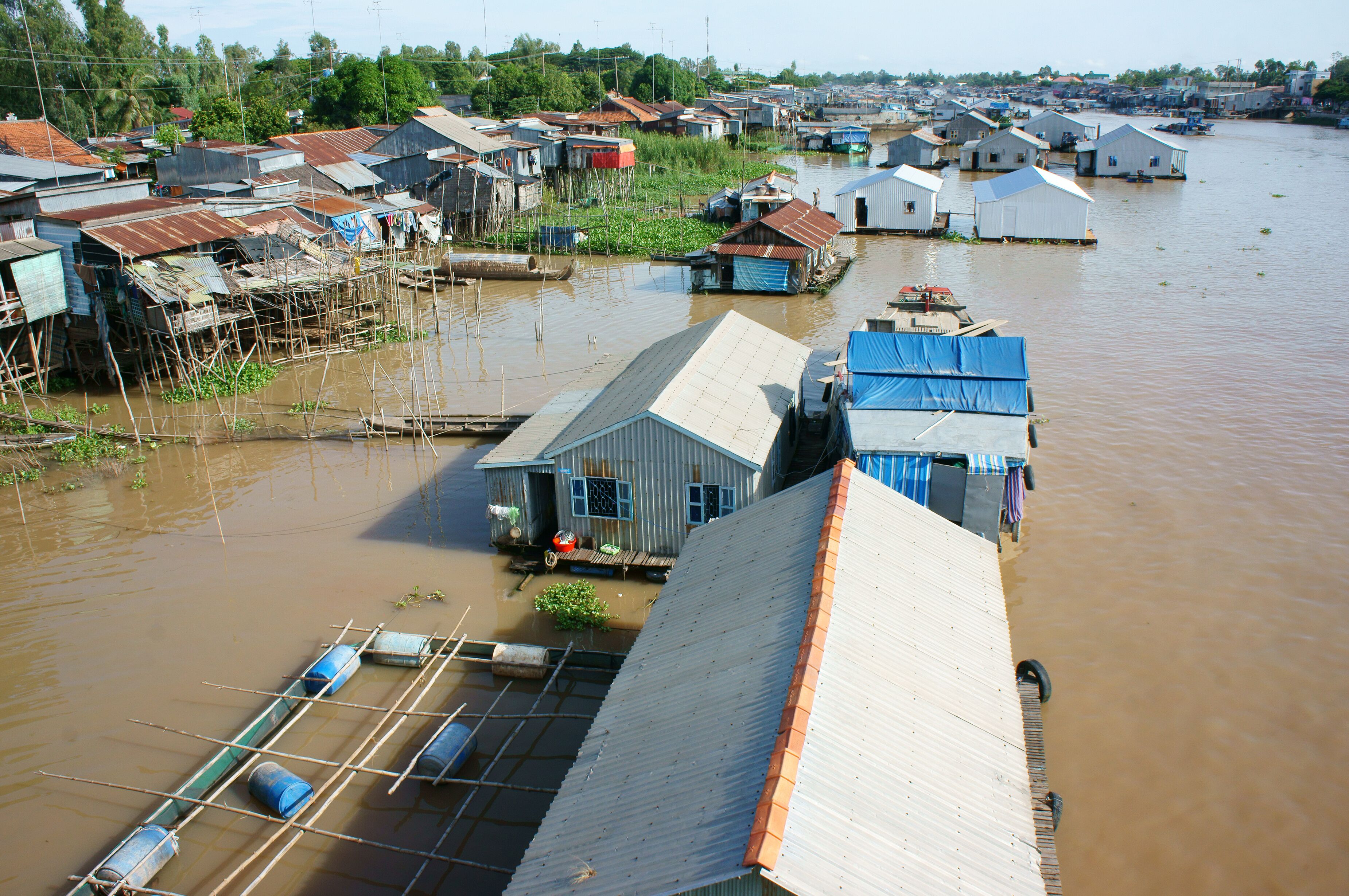 A waterlogged village with floating houses and boats.