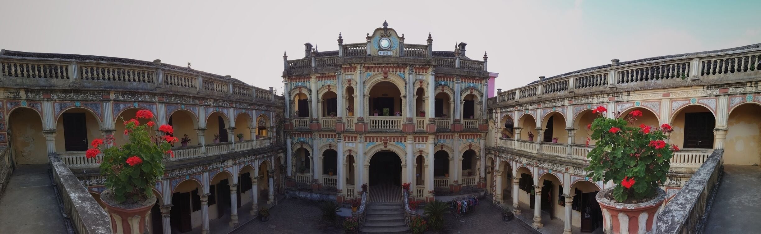 A historic building with ornate architecture, featuring multiple arches and balconies.