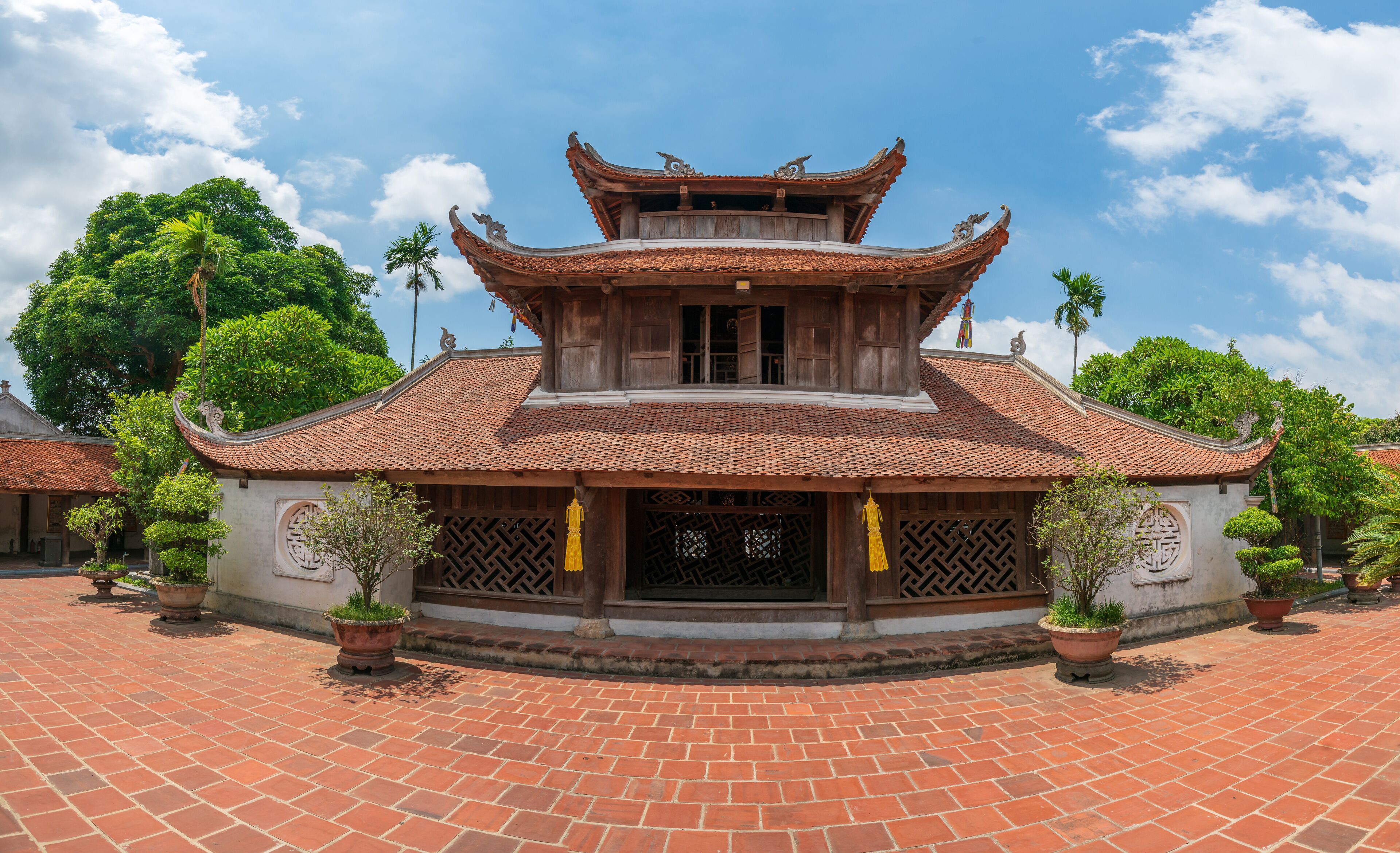 A traditional building with a tiled roof and ornate wooden eaves.